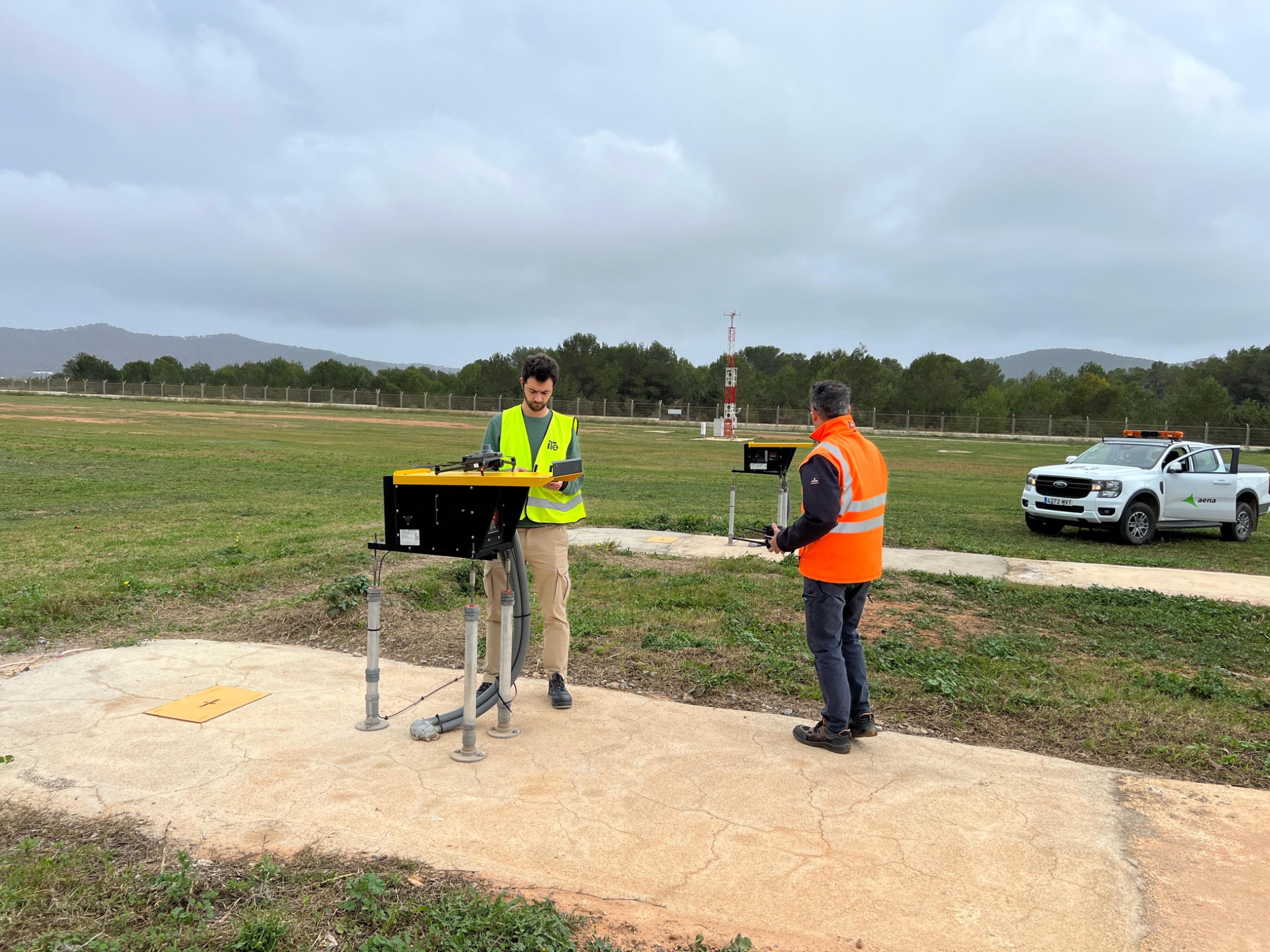 Personnel working with a drone and PAPI units at Ibiza Airport