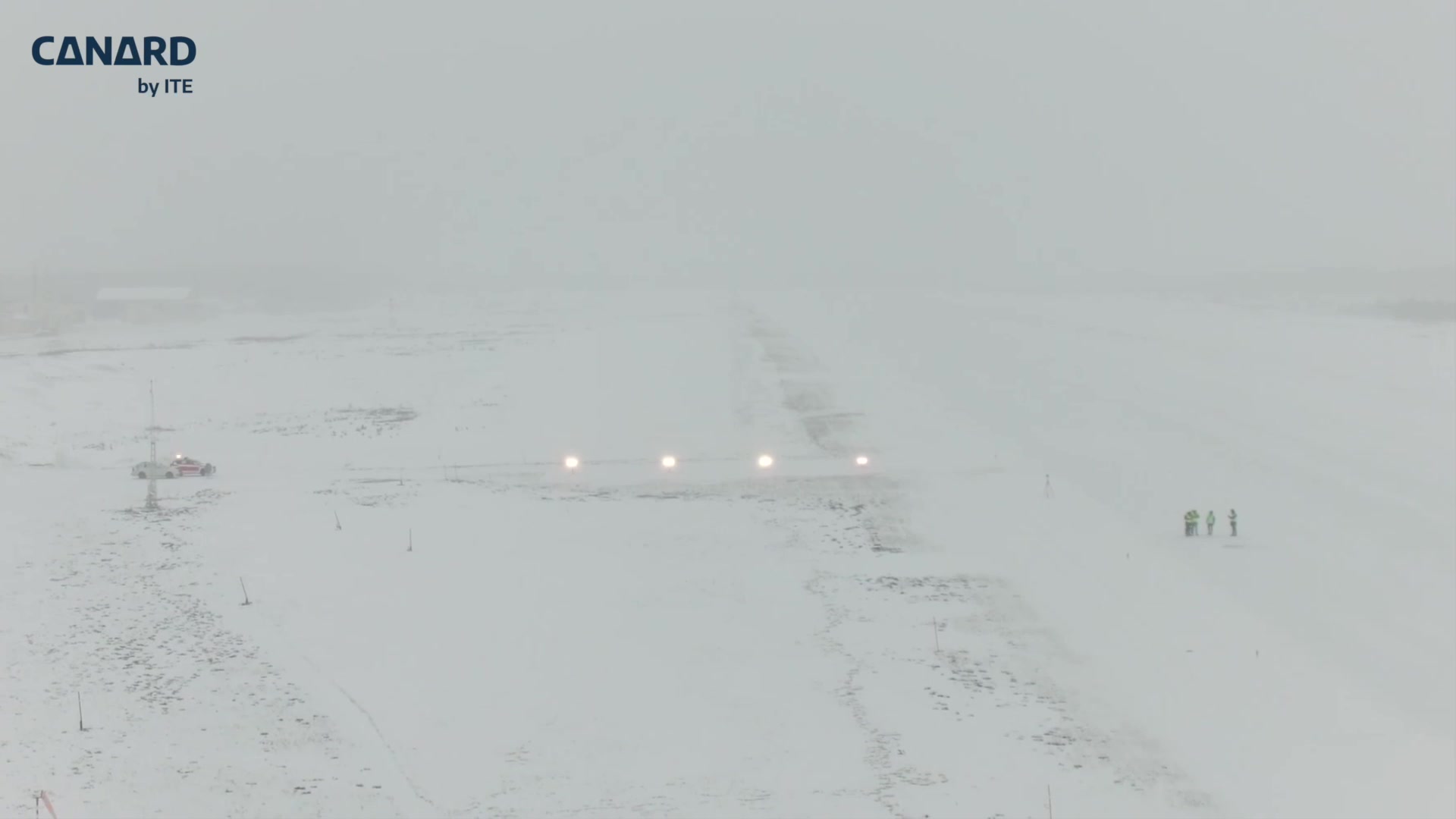 PAPI lights and inspection personnel at an airport covered in snow