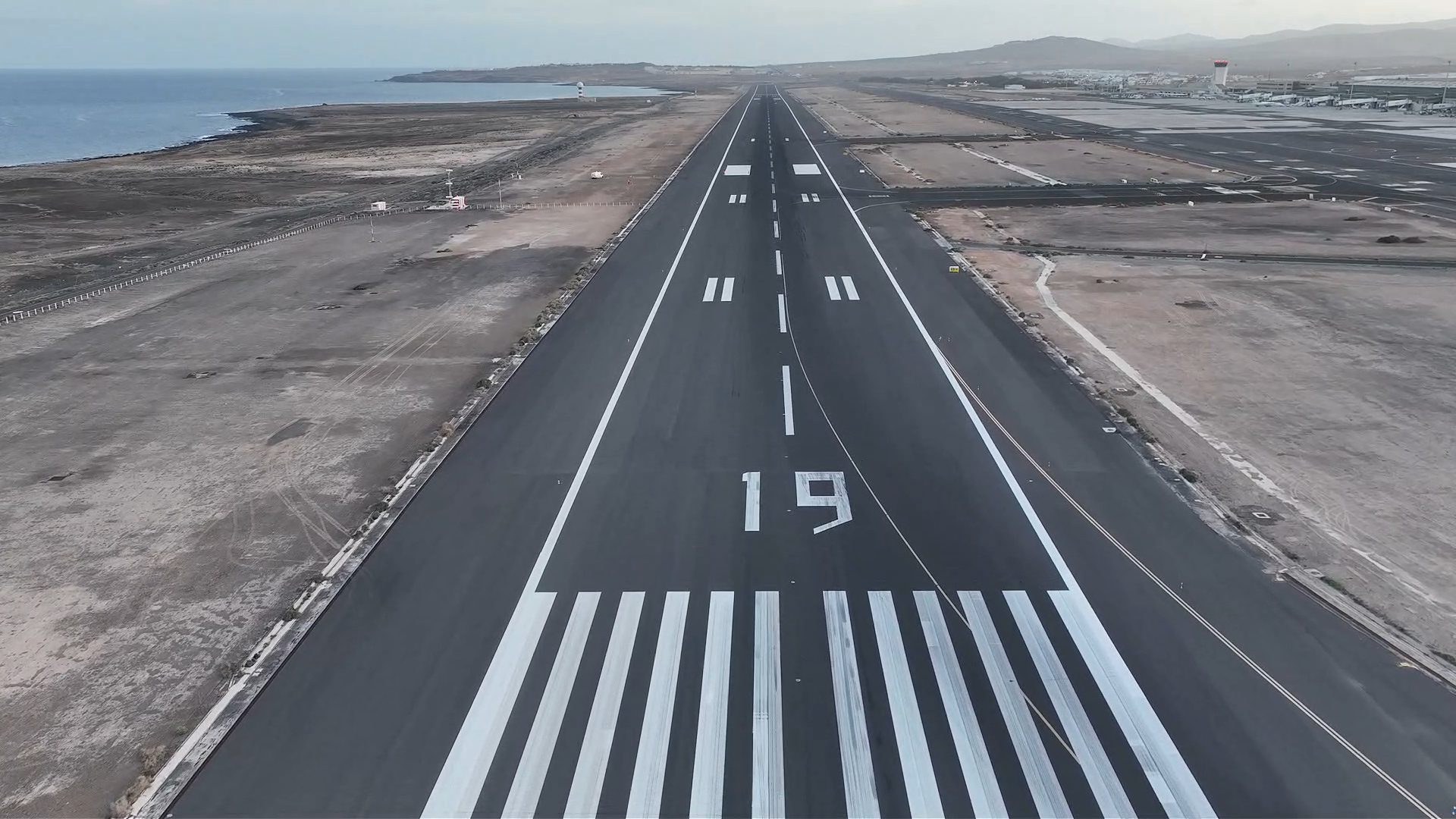 Aerial view of runway threshold, runway designation and painted runway markings